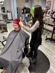 Hairstylist standing on ergonomic stylist mat. 